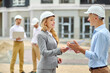 © zinkevych - Inspector handing over the building documentation to a chief engineer