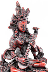 Wall Mural - Close up statue of goddess Saraswati with musical instrument