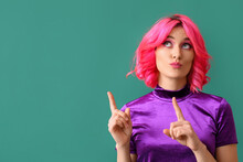 Stylish Woman With Bright Hair Showing Something On Color Background