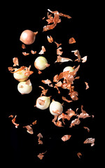 Wall Mural - Levitation flying onion, isolated on black background