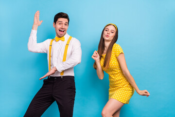 Poster - Portrait of two positive satisfied partners have fun discotheque fifties isolated on blue color background