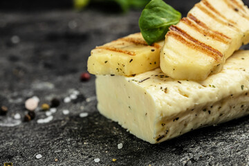 grilled slices of halloumi cheese with grill marks and mint. cyprus squeaky cheese. food recipe back