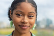 © Cultura Creative - Portrait of smiling young woman outdoors