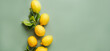 fresh lemons with green leaves on green background, flat lay. Eco friendly zero waste shopping. co2 neutral gardening. organic citrus fruits. sicilian lemons. fruit backgrounds