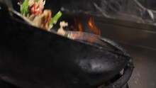 close up of moving wok with Thai fried rice