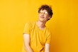 © Tatiana - guy with red curly hair wearing stylish glasses yellow t-shirt posing Lifestyle unaltered