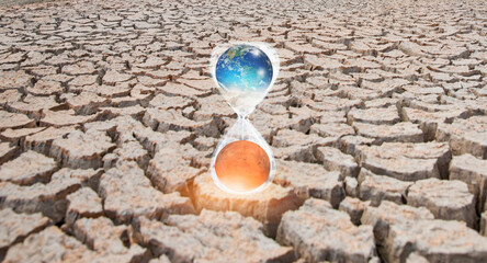 Poster - Global warming concept-Planet Earth is becoming a dead planet like Mars - Hourglass inside Planet Earth and Mars isolated-Cracked mud tiles in dry river bed 