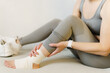 Sport injury leg pain - woman hurting holding painful sprained ankle muscle.
