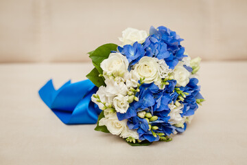 Wall Mural - Bride's bouquet in blue and white colors with a big blue bow. vertical template stories