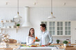 © BestForYou - Young beautiful couple with juice standing at kitchen. Healthy eating, time together