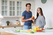 © BestForYou - Portrait of young couple in the kitchen with carrot juice. Healthy eating