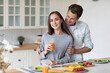 © BestForYou - Romantic young couple in love, man and woman hugging and having a great time together in the kitchen at home. Couple life
