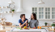 © BestForYou - Young couple in the kitchen while preparing a vegetarian breakfast.