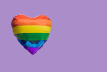 A Rainbow Color Heart Shaped Balloon With Copy Space. Very Peri Background. LGBT Liberation Abstract Concept.