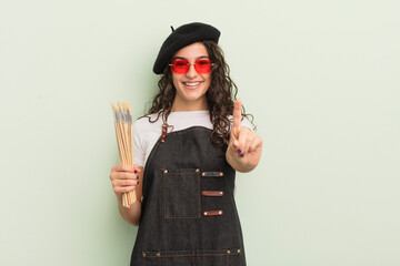 Wall Mural - young pretty hispanic woman smiling and looking friendly, showing number one. artist concept