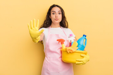 Wall Mural - young pretty hispanic woman smiling and looking friendly, showing number five. housework an clean products concept