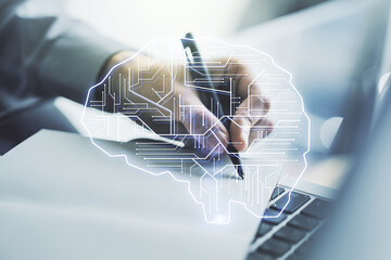 Wall Mural - creative artificial intelligence concept with human brain hologram and hand writing in notebook on b