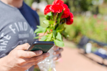 closeup of man hands holding a phone sending messages with blurred background