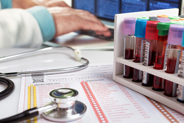 Sticker - Doctor working with Hematology blood analysis report with rack blood tubes and stethoscope. Blood tubes tests for Medical test in the laboratory