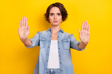 Poster - Photo of young lady show palms no refuse rejection sign enough isolated over yellow color background