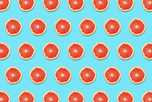 Grapefruit Slices On A Blue Background In A Pattern