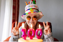 Cheerful Elderly Woman Celebrating Birthday With Cake
