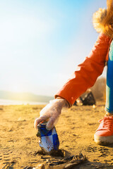 Wall Mural - Detail of an aluminium can being picked by a volunteer from the beach