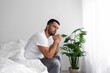 © Prostock-studio - Pensive sad tired millennial muscular european male sitting on bed suffering from depression and stress alone