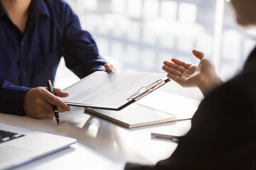 Wall Mural - Applicants submit resumes and job interviews. Businessman holding a resume is interviewing for a job in the office.