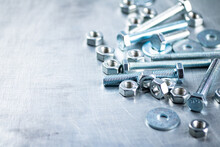 Working Tool. Nuts And Bolts On The Table. On A Gray Background. High Quality Photo