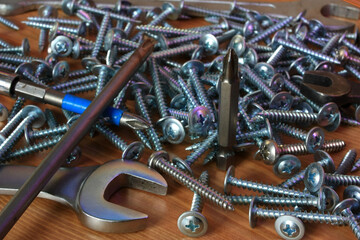 Metal screws, screwdriver bits and spanners