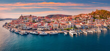 Fantastic Sunset In Poros Town. Picturesque Summer Seascape Of Myrtoan Sea With A Lots Of Yachts. Attractive Evening Scene Of Peloponnese Peninsula, Greece. Traveling Concept Background..