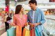 © Prostock-studio - Happy Couple Shopping Holding Paper Shopper Bags In Mall