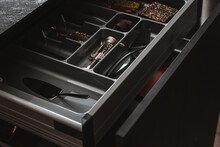 Modern kitchen. Open drawers with kitchenware and utensil. Soft closing inner drawer ideas.