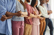 © Studio Romantic - Diverse team of different happy young people standing together. Multiethnic group of good friends standing in a row, holding hands and smiling. Teamwork, unity and diversity concepts