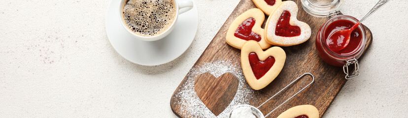 Wall Mural - Board with tasty heart-shaped cookies and jam with cup of coffee on light background with space for text. Valentine's Day celebration