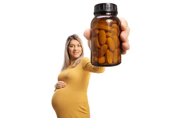 Wall Mural - Pregnant woman holding a bottle of pills in front of camera