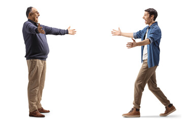 Canvas Print - Full length profile shot of a mature and younger man greeting each other with arms wide open