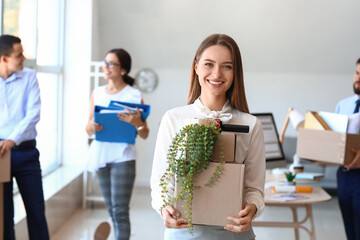 Poster - beautiful woman holding boxes with things in office on moving day