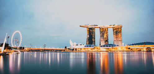 Wall Mural - SINGAPORE, SINGAPORE - MARCH 2019: Skyline of Singapore Marina Bay at night with Marina Bay sands, Art Science museum , skyscrapers and tourist boats