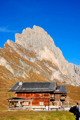 Wall Mural - Traditional wooden chalet in the Dolomites, in autumn landscape, Italy, Europe