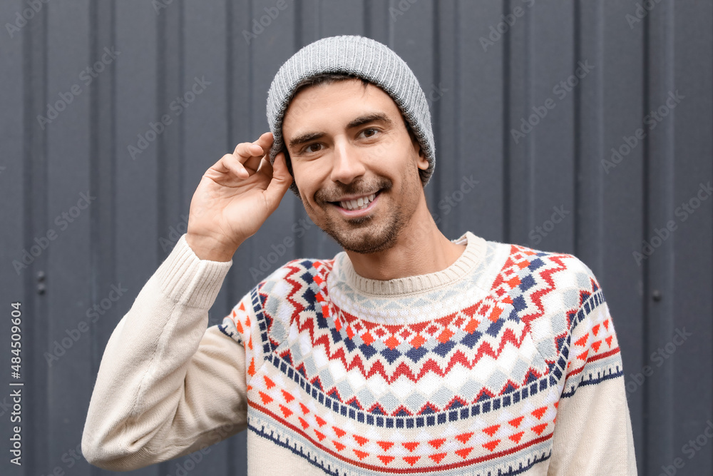 Handsome young man in knitted sweater outdoors