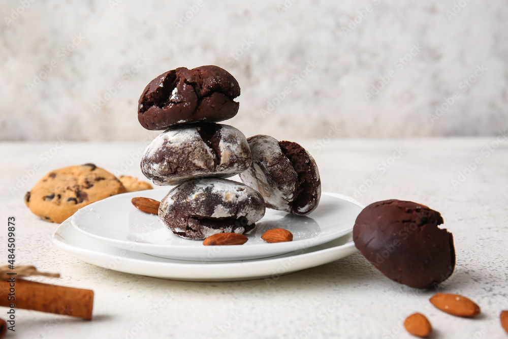 Plates of chocolate brownie cookies on light background