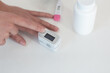 Pulse oximeter on a woman's finger. blood oxygen saturation. The patient measures the saturation of the blood with an electronic pulse oximeter on the finger