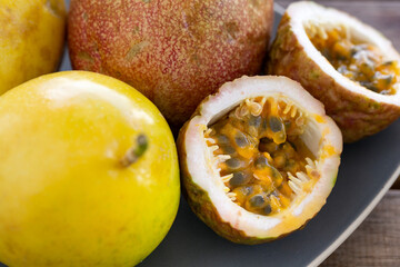 Wall Mural - Exotic passion fruit on plate, tropical food