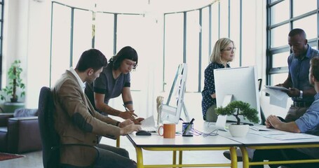 Poster - Getting everyone in on the project. Group of businesspeople at work in a modern office. Group of five diverse businesspeople working and talking around a desk in a modern office at work.