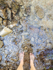 Canvas Print - A vertical shot of a man standing near the river in Cercedilla, Spain