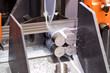 © warut - steel rods cutting by band saw machine with coolant fuid