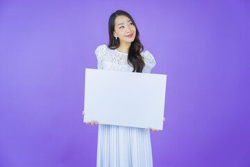 Wall Mural - Portrait beautiful young asian woman with empty white billboard