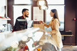 © fotofabrika - Shop assistant handling shopping bag to female customer in grocery store